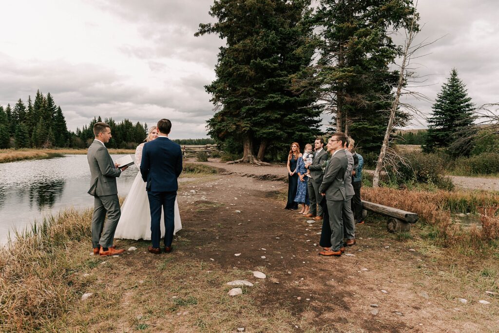 small intimate wedding ceremony at schwabacher landing on a rainy, fall day taken by adrian wayment.