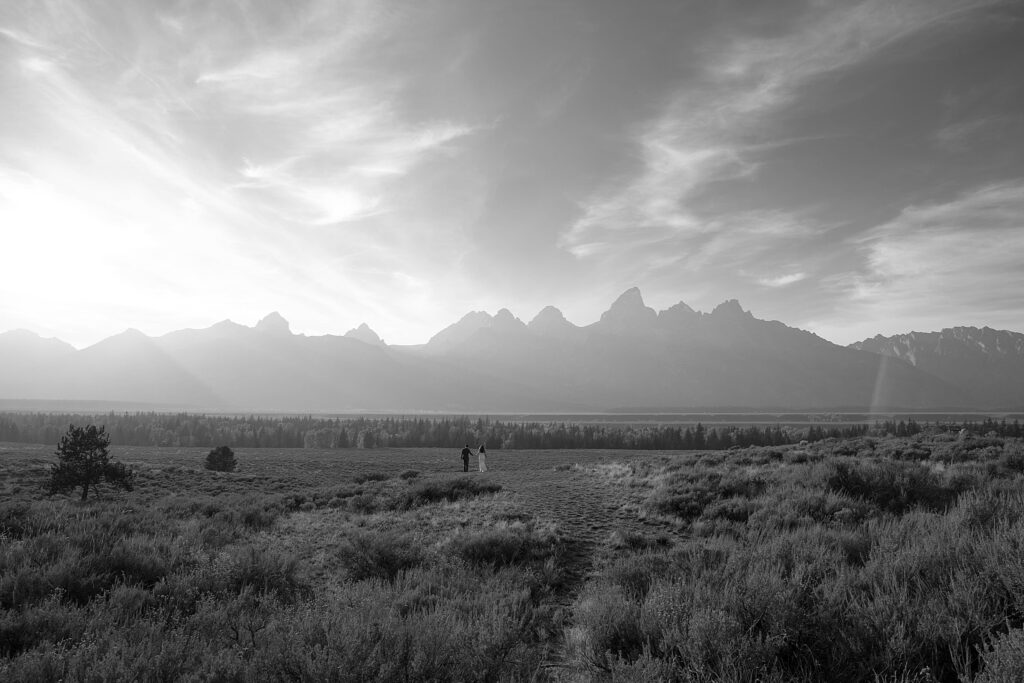 bride and groom in front of the grand tetons captured by local jackson hole photographer adrian wayment taken after their wyoming elopement.