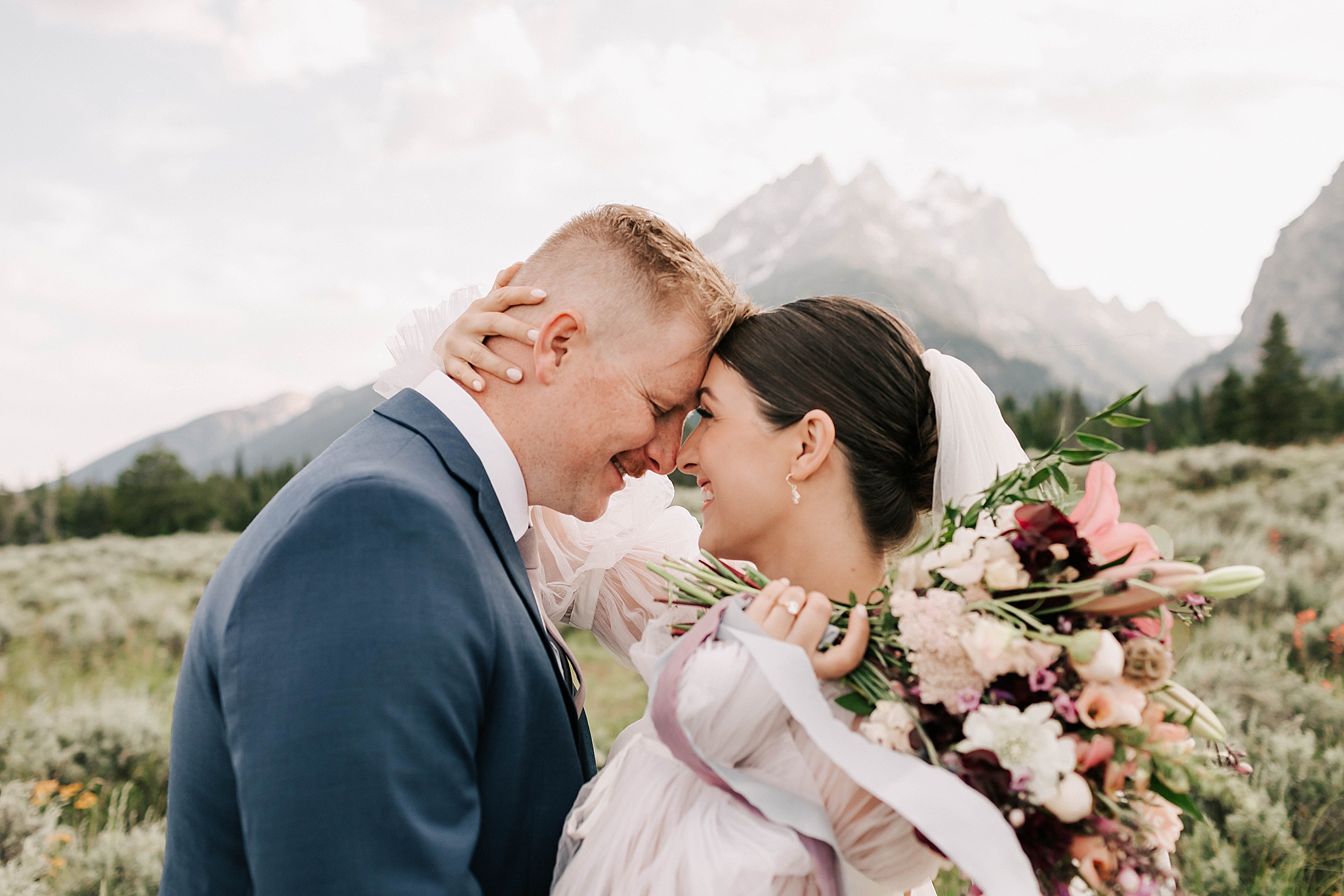 bride and groom in front of the tetons for their grand teton elopement taken by adrian wayment.