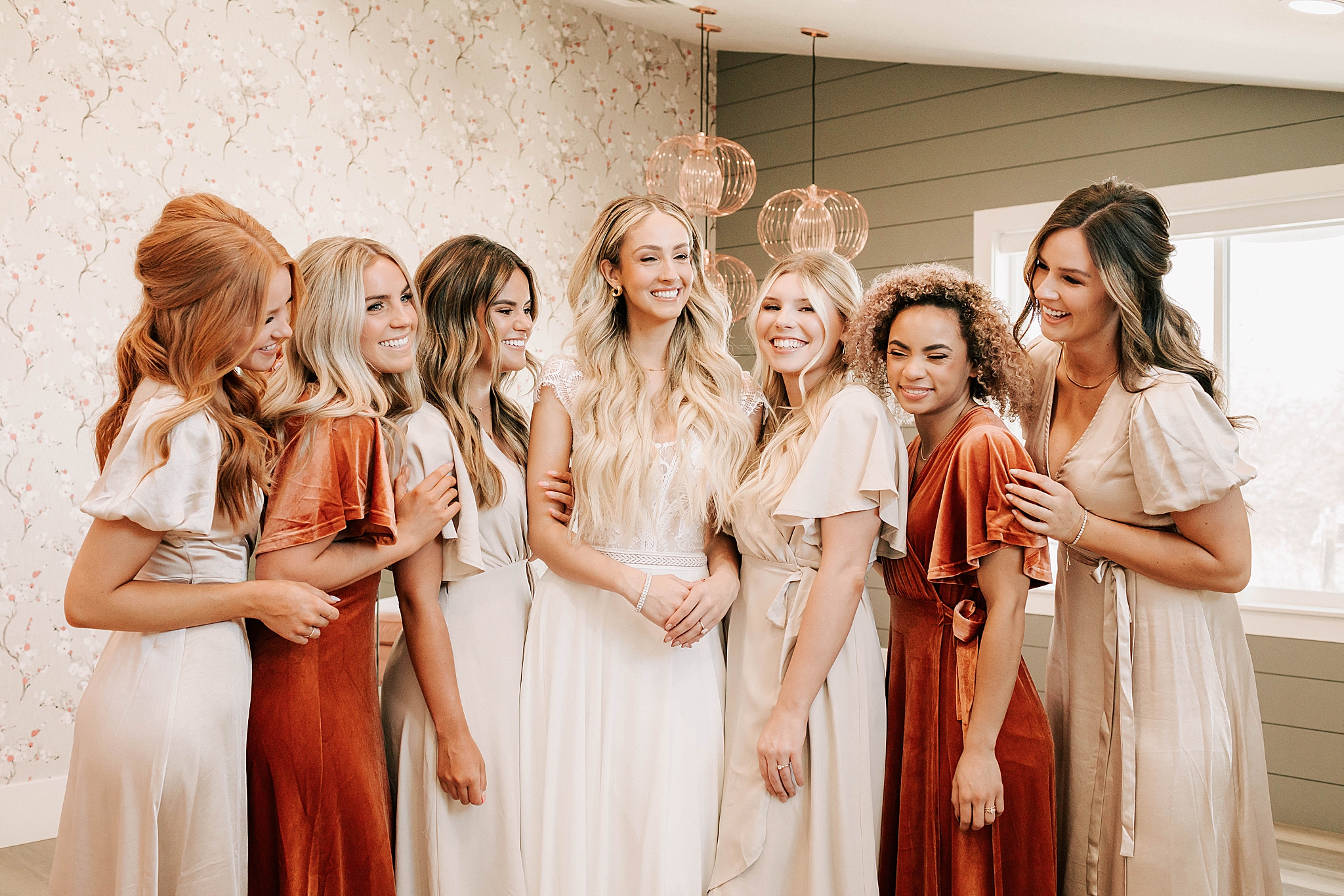 bridal party laughing together in bridal suite at jackson hole wedding venue taken by adrian wayment photo