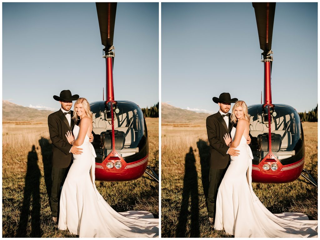 bride and groom standing next to each other in front of a jackson hole helicopter.