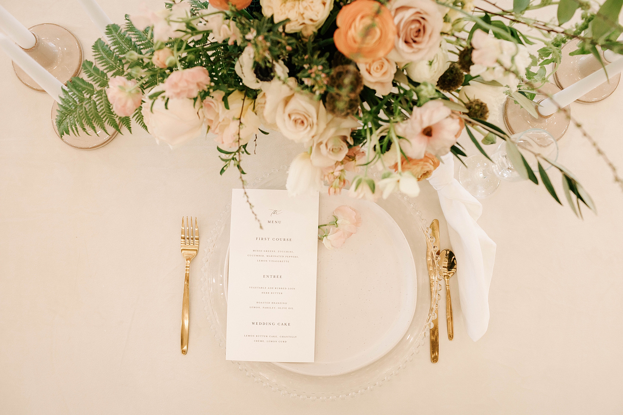 wedding setting with flowers, menu, plates and silverware at a split creek ranch wedding.
