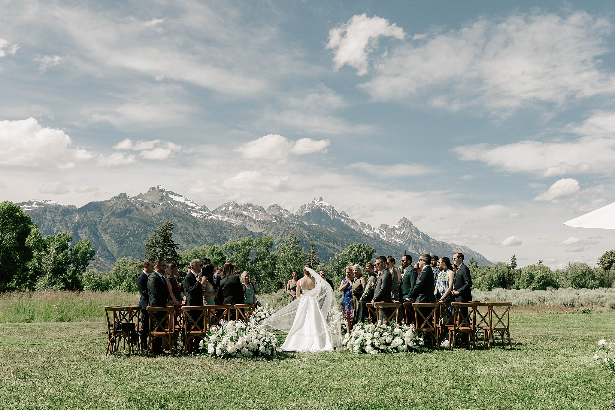 a bride walking down the aisle at her split creek ranch wyoming wedding taken by local jackson photographer adrian wayment.