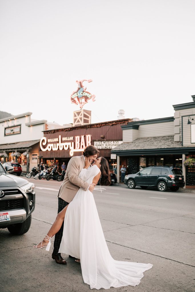 bride and groom standing outside of the million dollar cowboy bar after their ceremony.