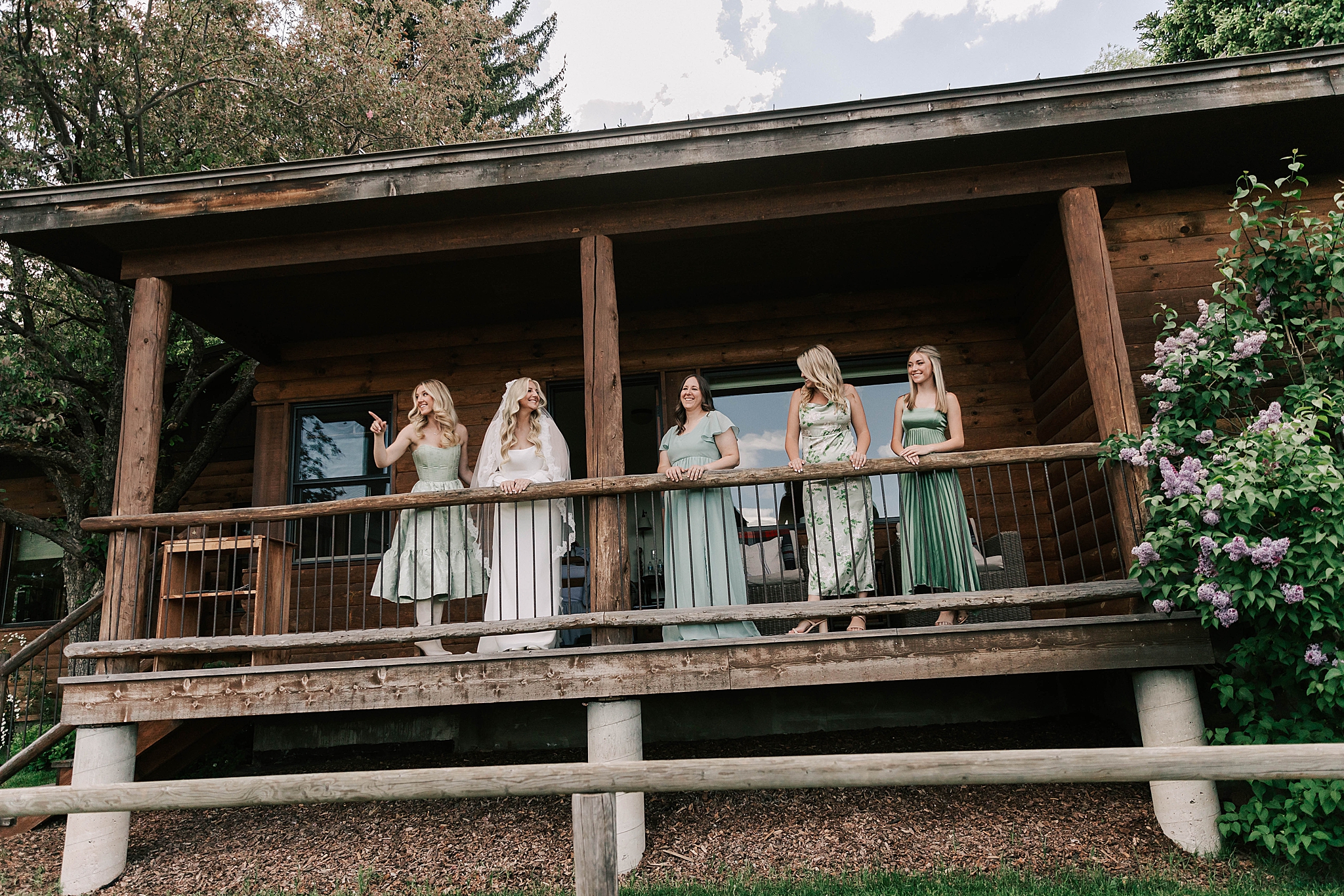 bridal party standing on a balcony before the trail creek ranch wedding