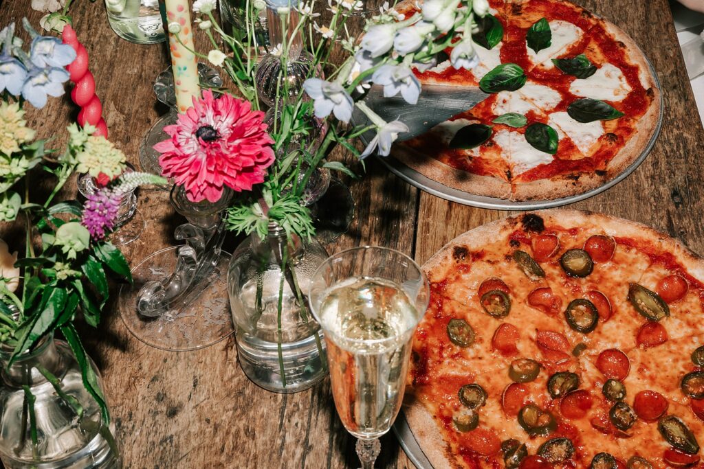 pizza, florals and Champaign taken at a moose creek ranch wedding by local photographer adrian wayment.