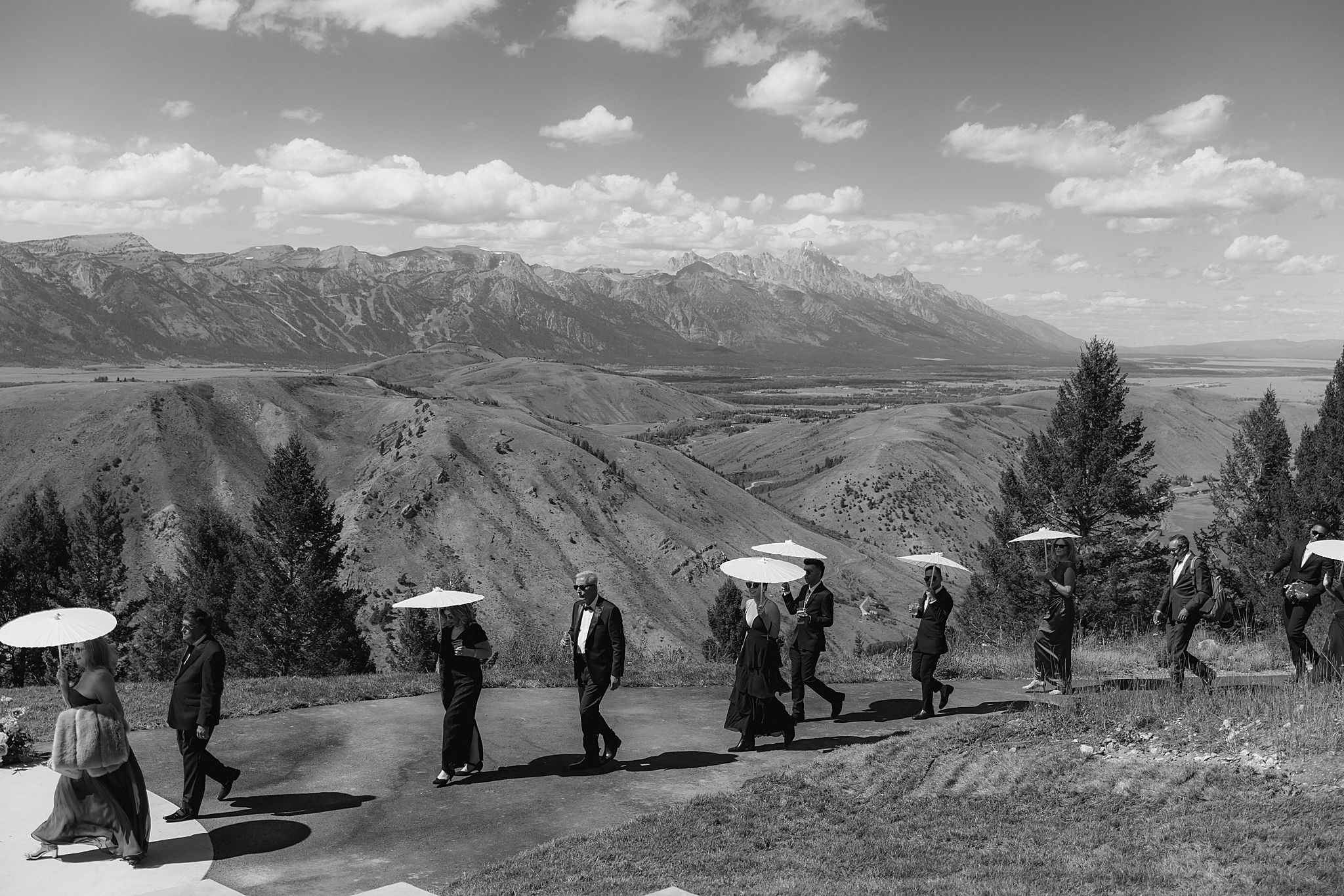 guests walking to the ceremony site at an aurora at snow king wedding venue taken by local jackson wedding photographer adrian wayment.